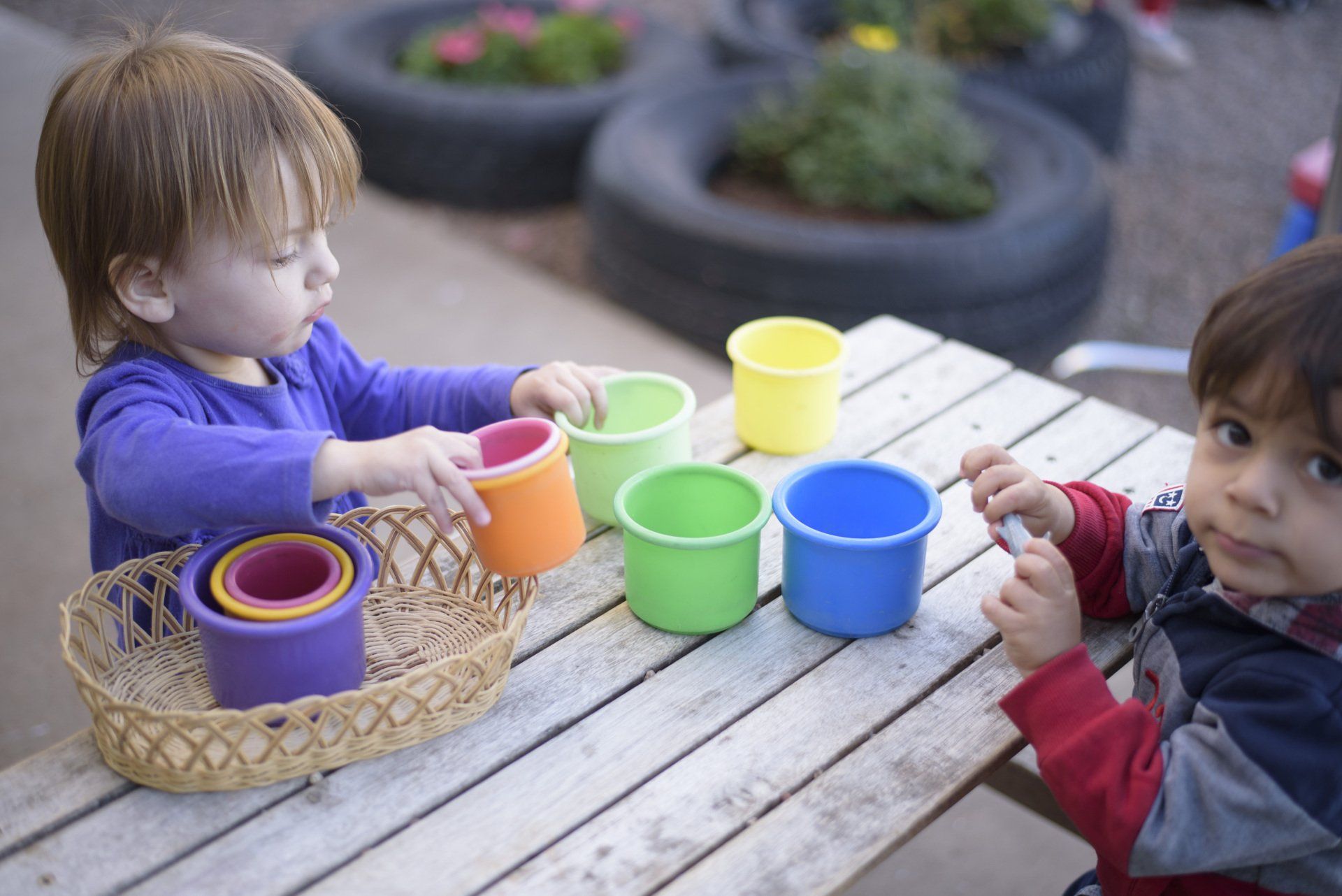 Montessori toddlers working outdoors