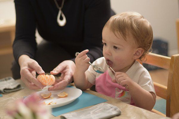 Montessori infant eating a snack
