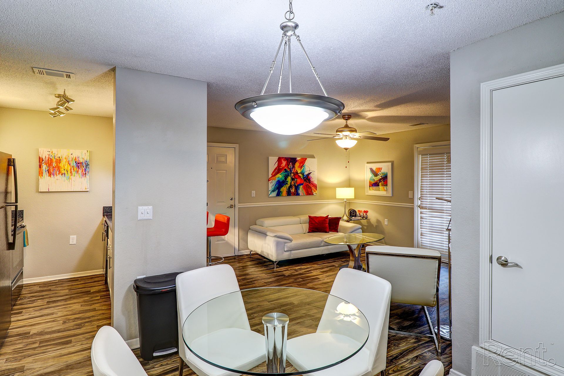 A living room with a dining table and chairs and a couch.