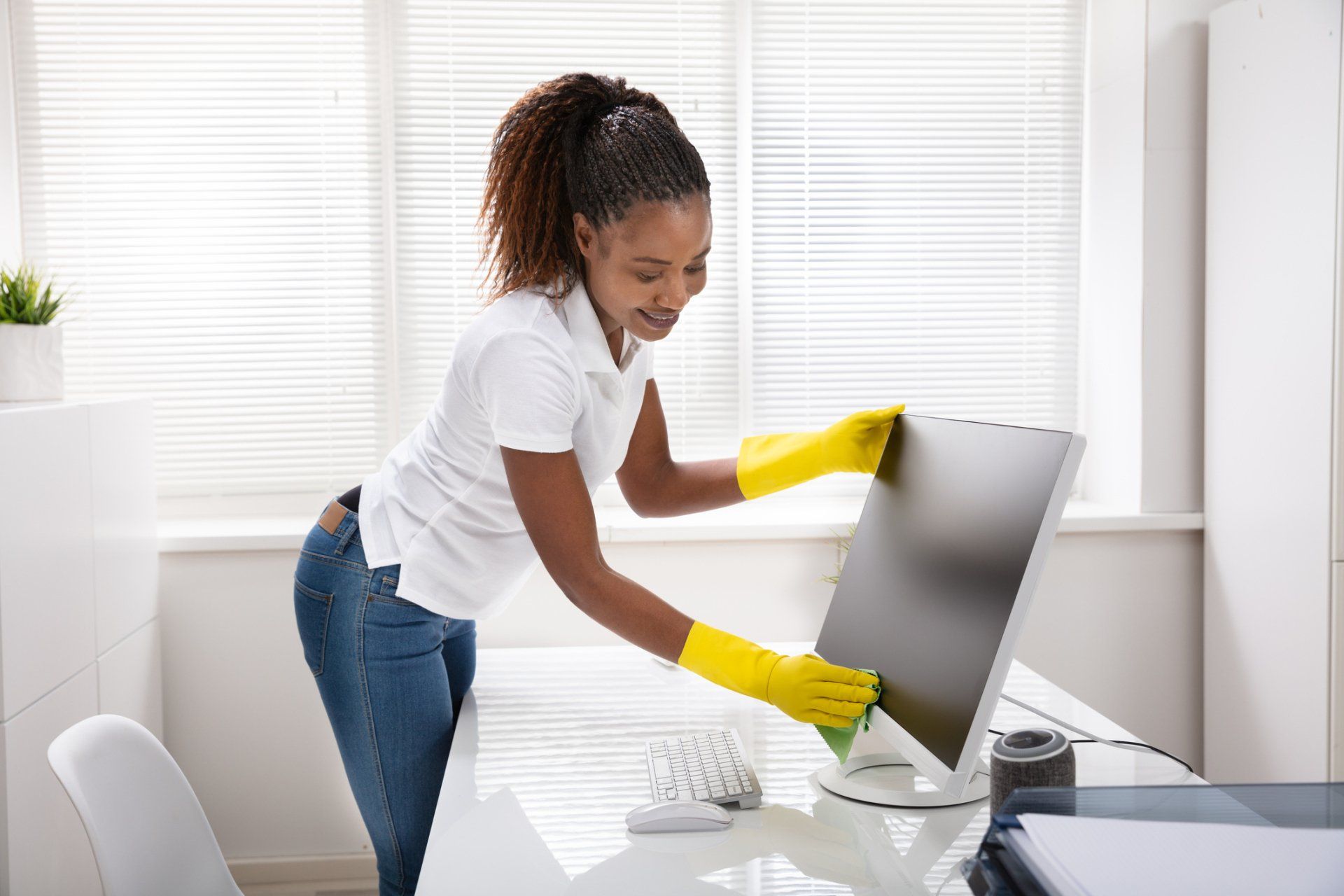 Woman Cleaning the Office Equipments — Mobile, AL — Sunshine Commercial Cleaning