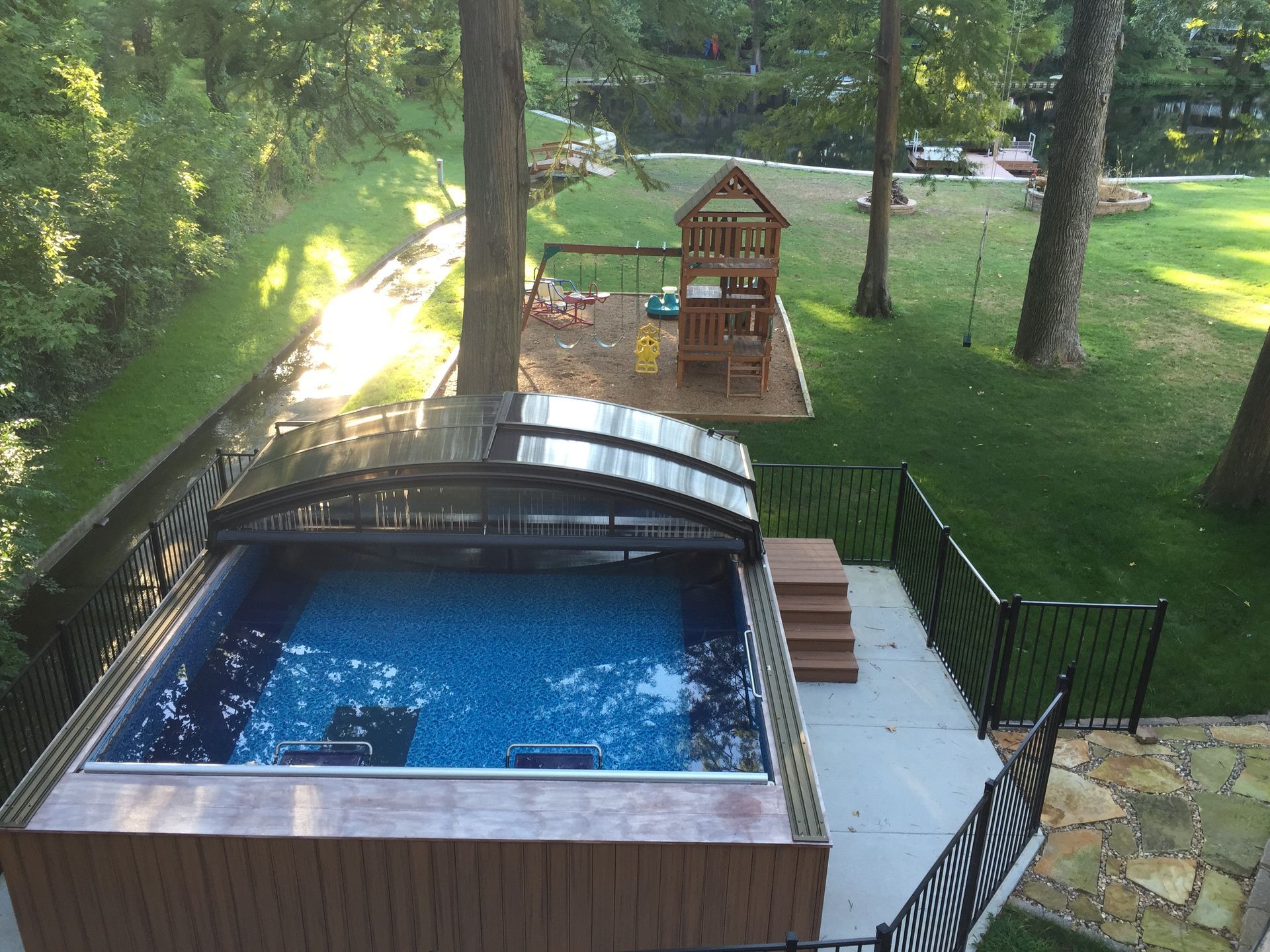 Retractable enclosure over swim spa