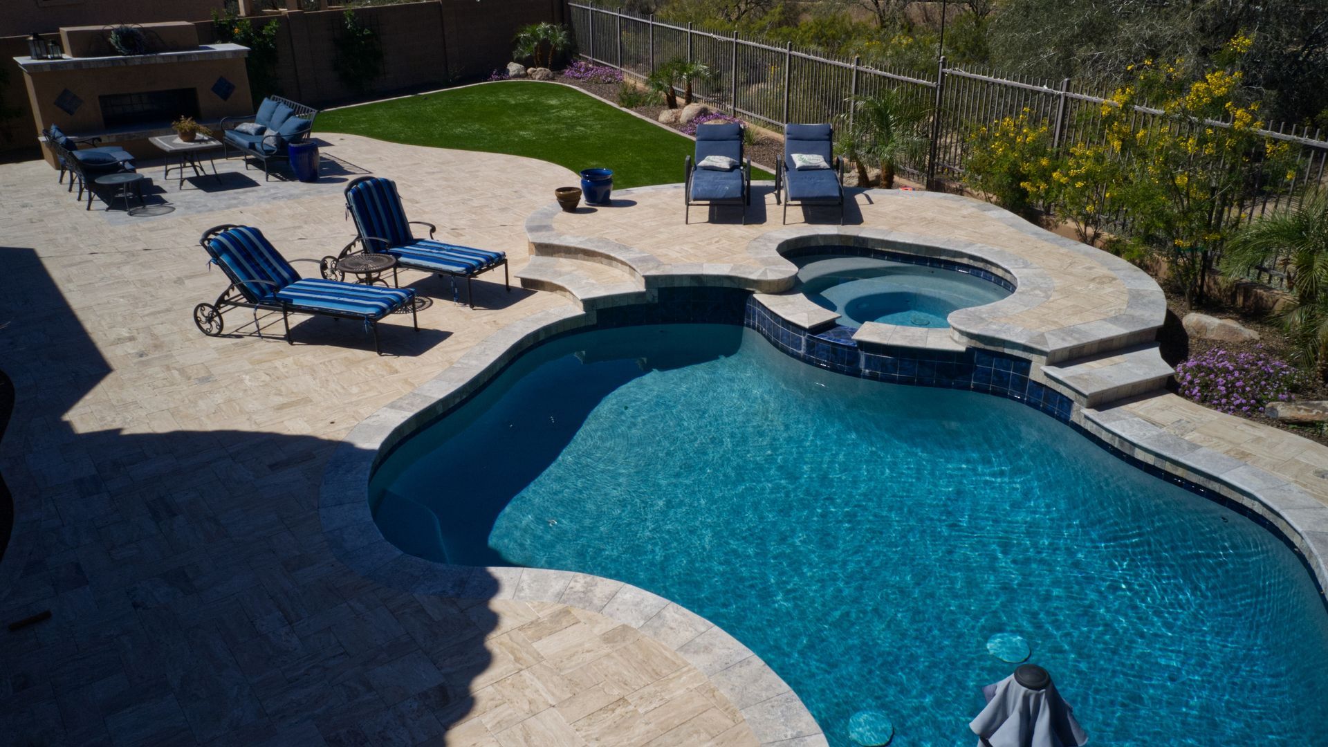 an Aerial view of a desert landscaped travertine pool deck.