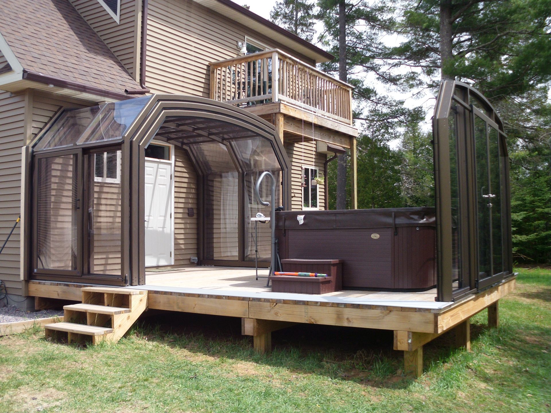 Retractable enclosure over deck and hot tub