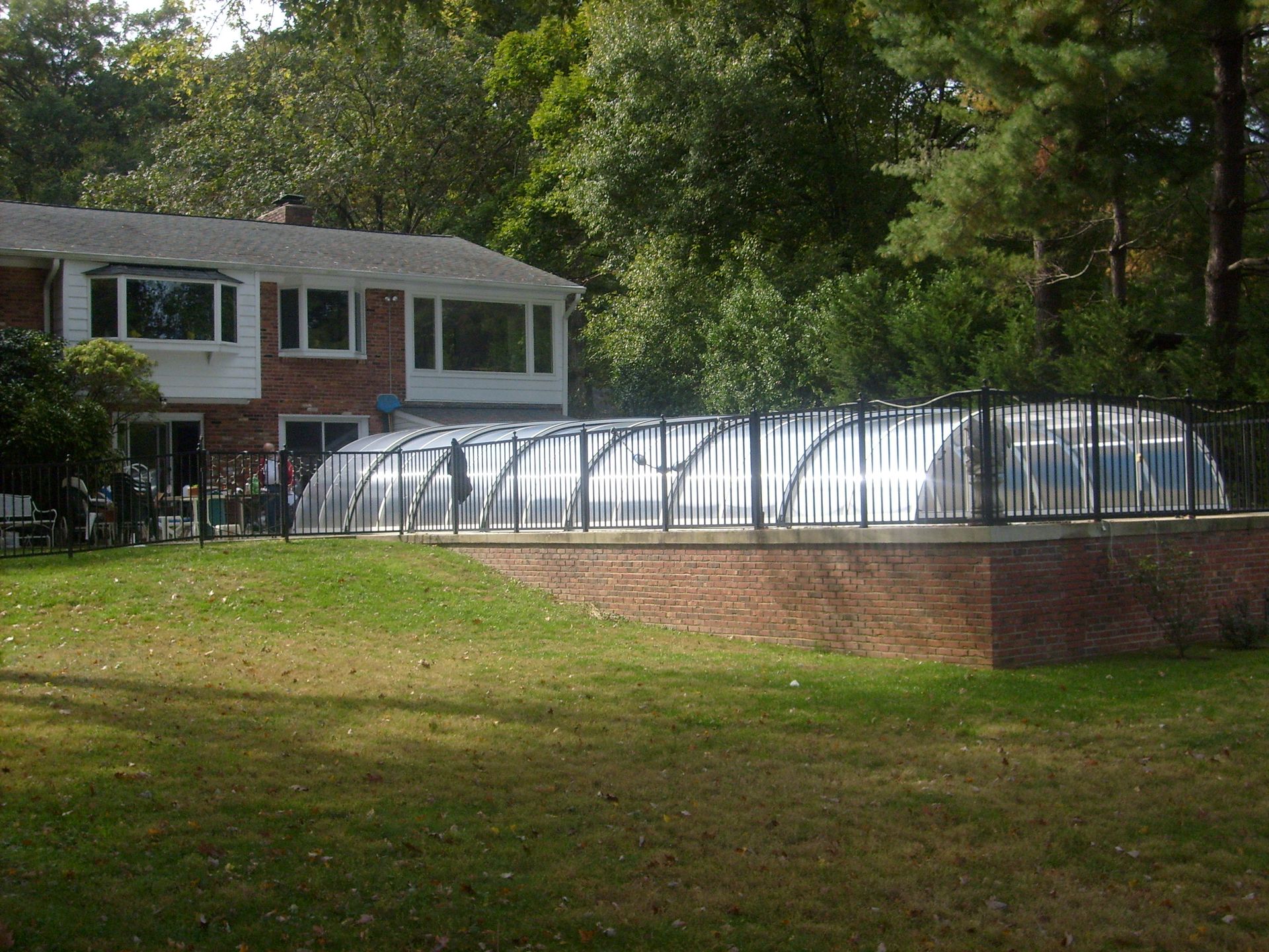 Retractable enclosure on pool deck