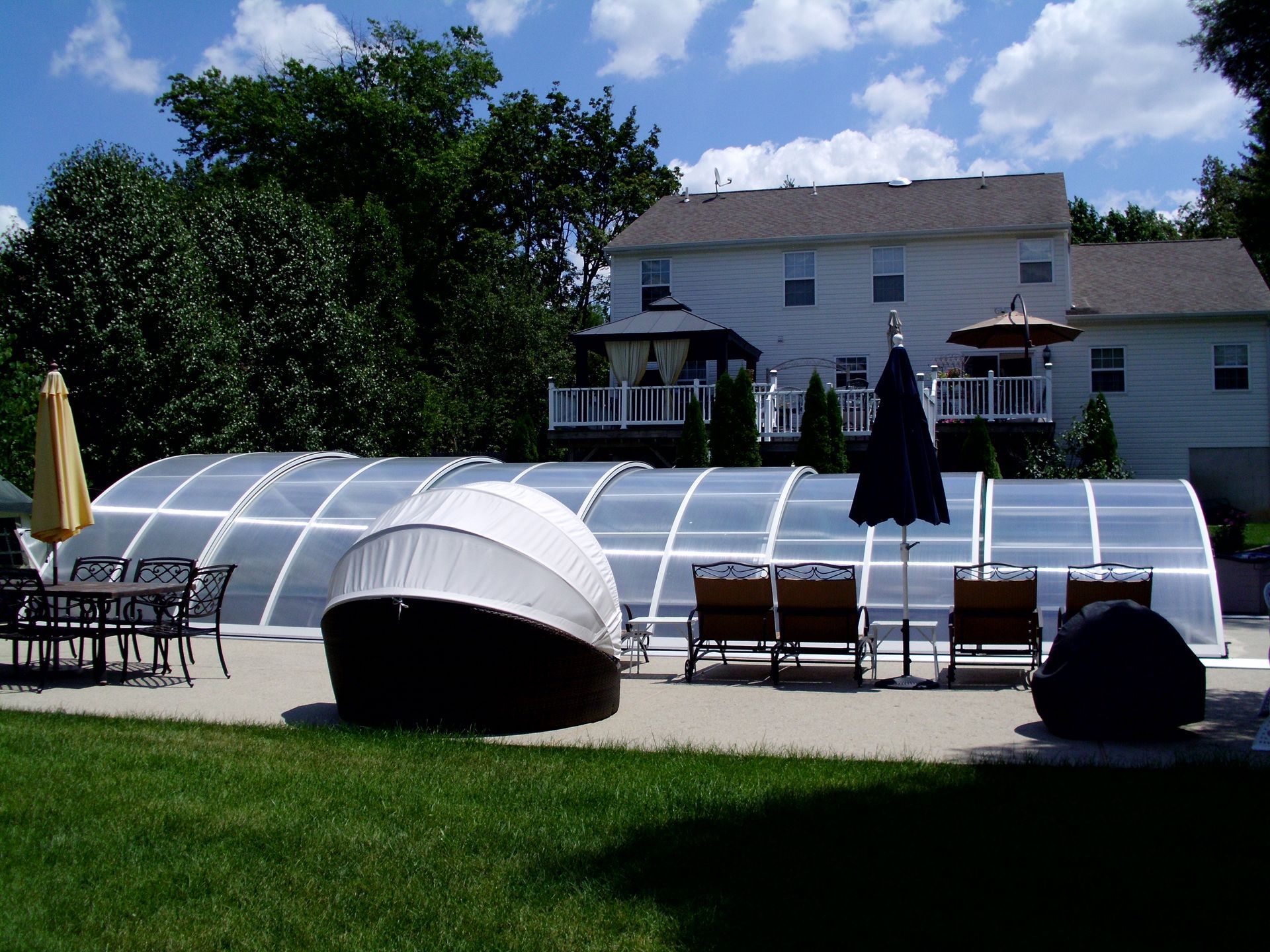Retractable pool enclosure covering swimming pool.