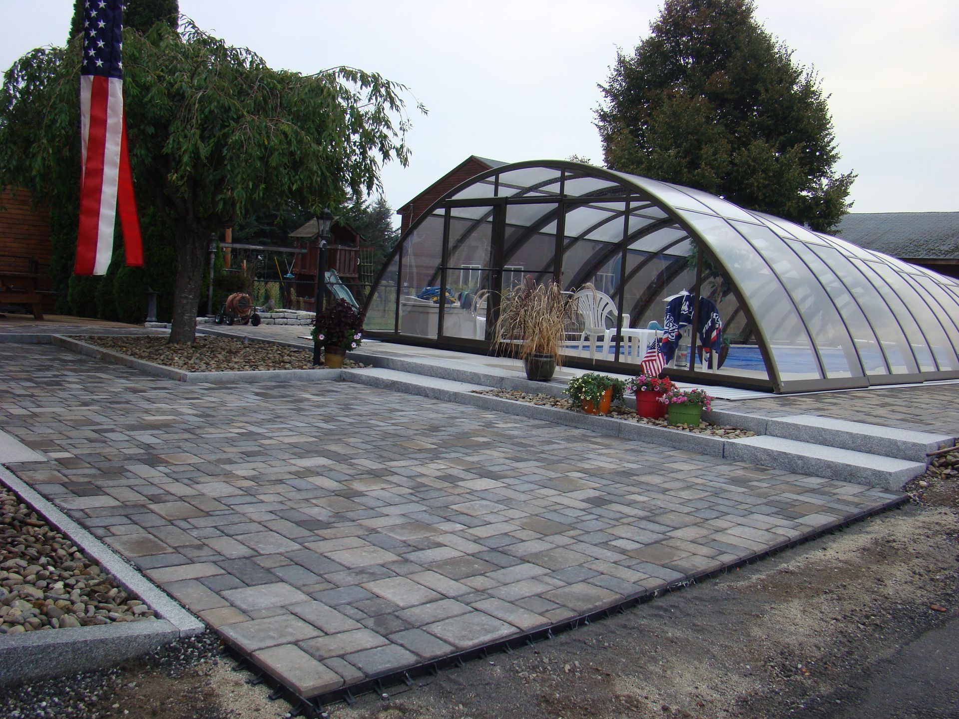 Stylish retractable enclosure with paver decking