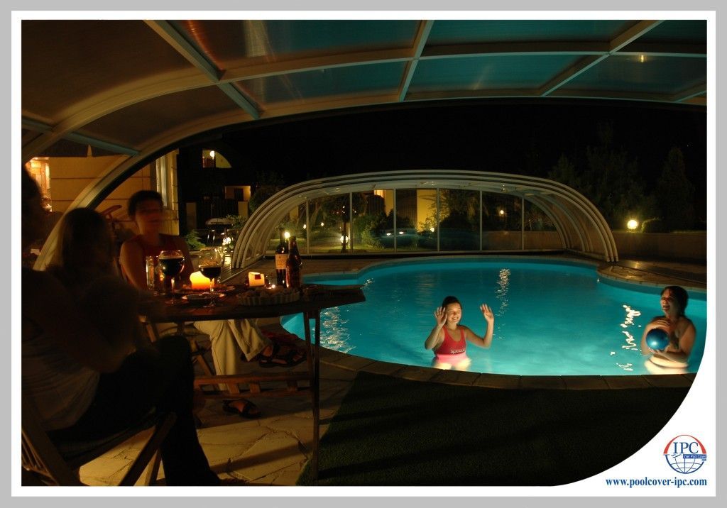 Swimming at nigt with retractable enclosure open