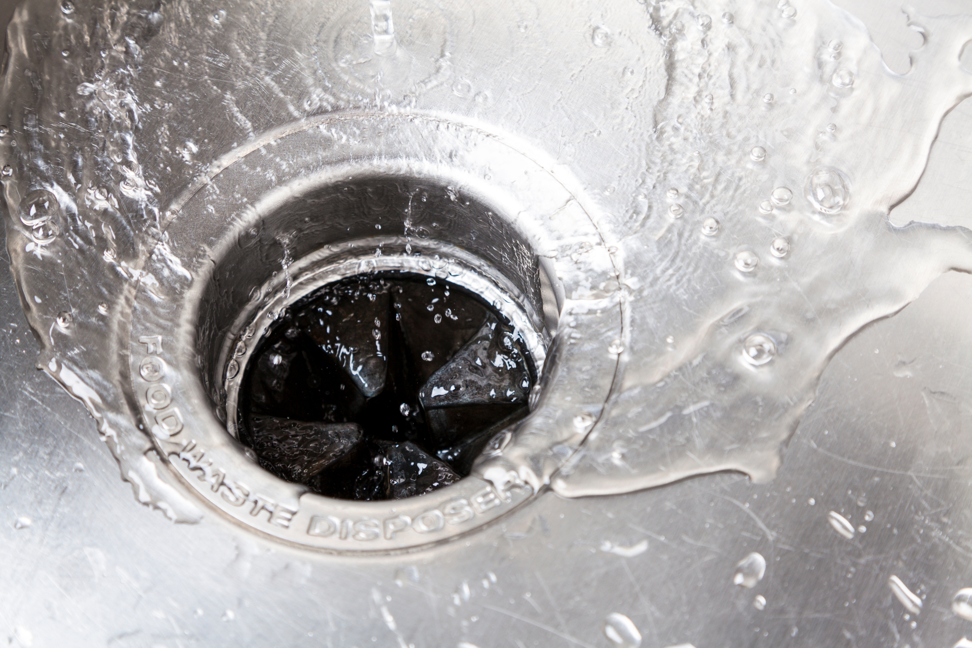 A close up of a sink with water coming out of it.