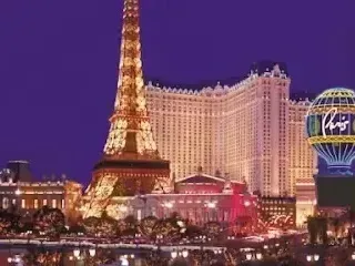 Henderson Artificial Turf- The Paris Las Vegas Hotel and Casino is shown at night, featuring a replica Eiffel Tower and illuminated signage against a deep blue sky.