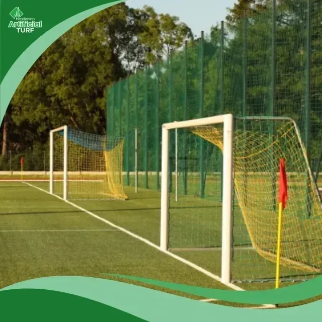 Henderson Artificial Turf -Soccer goals with yellow nets stand on an artificial turf field with white markings and a red corner flag.