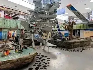Henderson Artificial Turf - A vibrant indoor play area featuring a tall, spiral water slide, interactive water features, and playful structures for children.