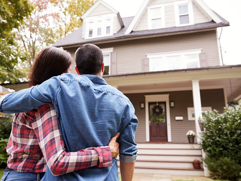 Couple in Front of House — Johnson City, TN — Insurance Solutions by Rutledge & Associates