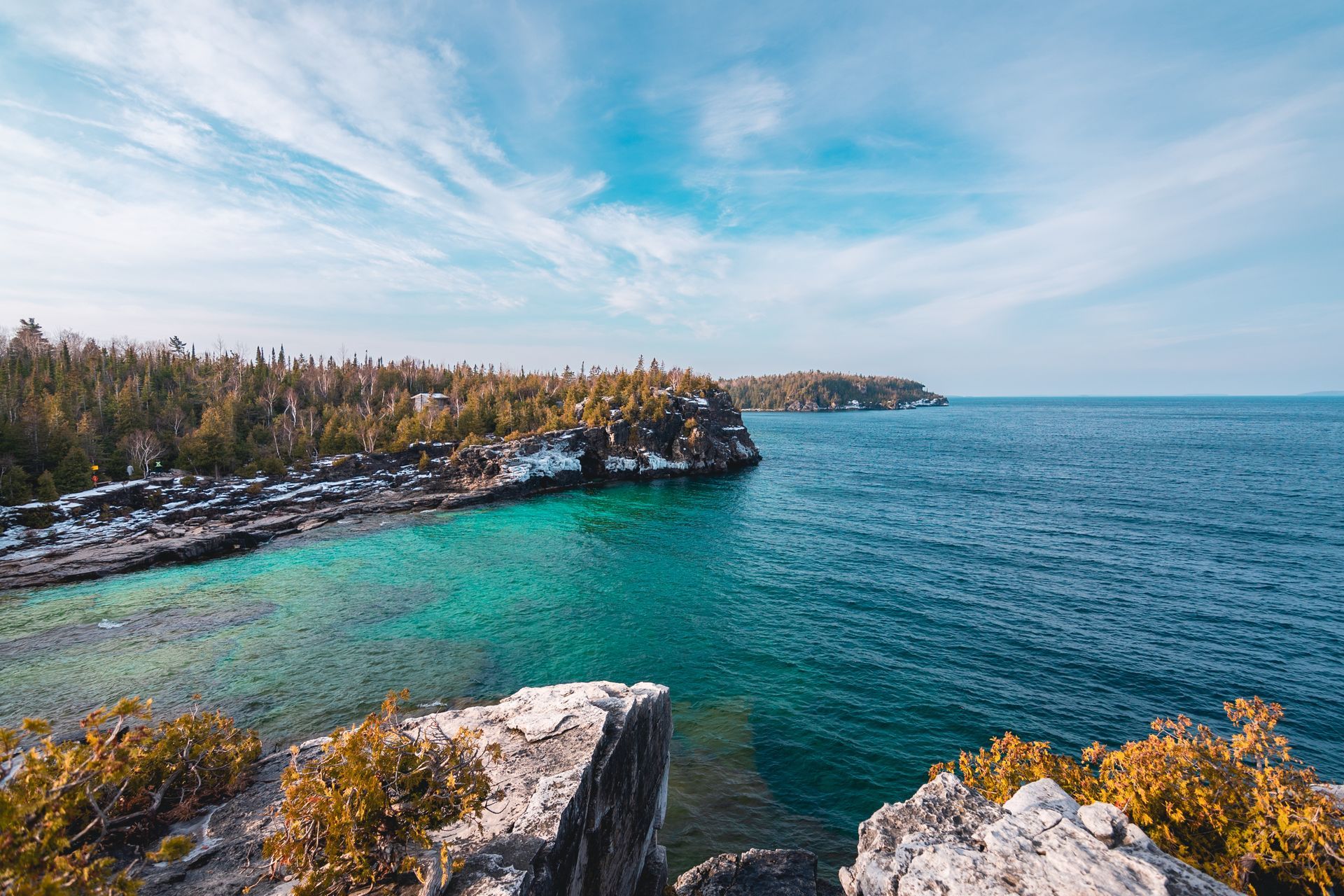 A view of a large body of water from a rocky cliff.