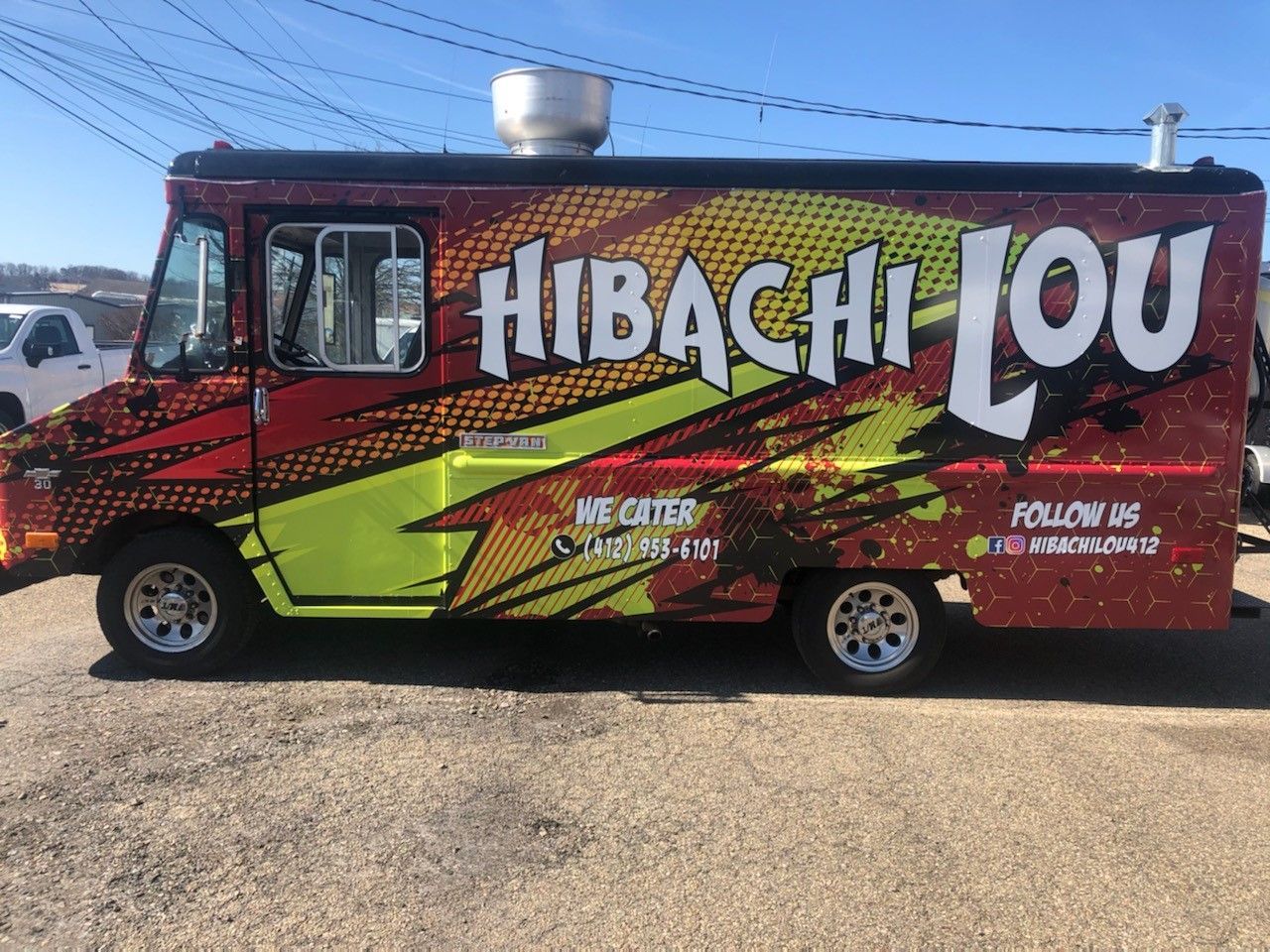 Hibachi Lou food truck, red/yellow design, parked outdoors. Text says 
