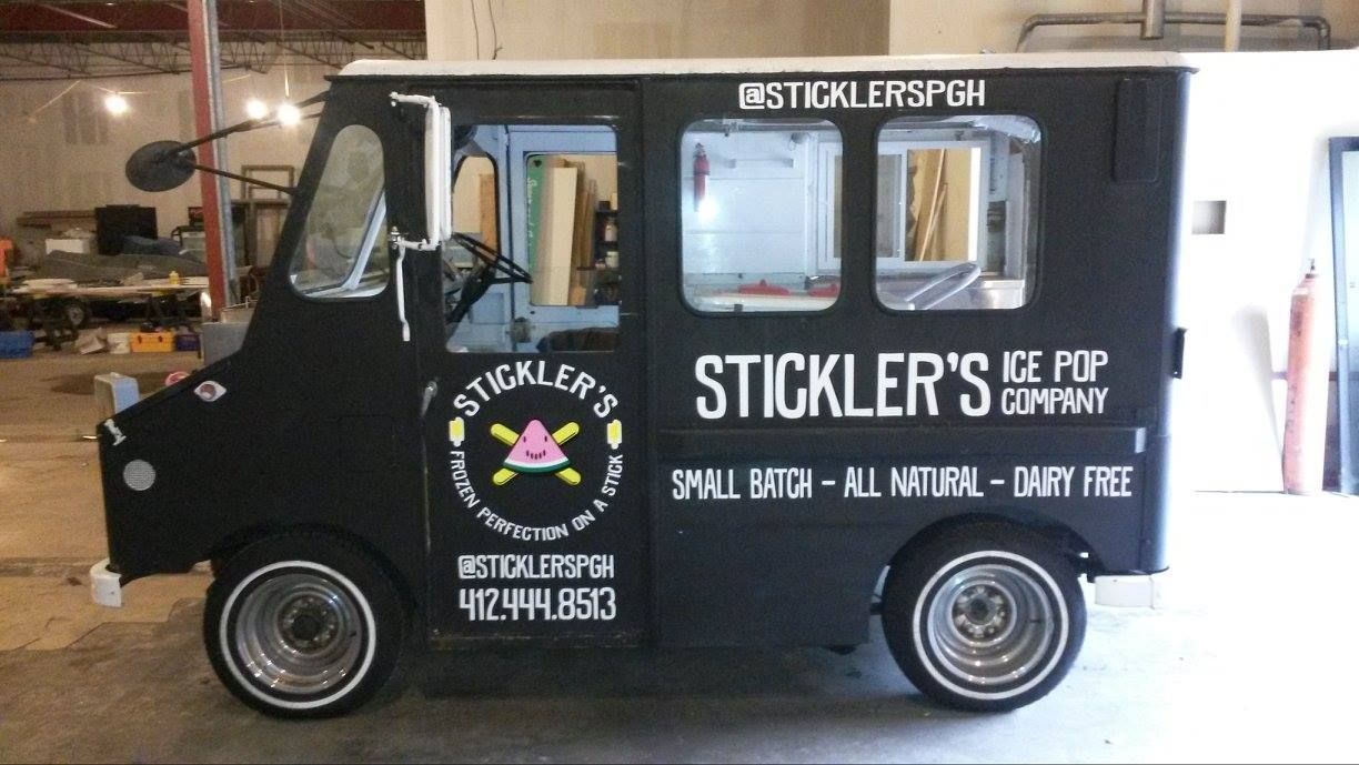 Black Stickler's Ice Pop Company truck with logo and text advertising its products.