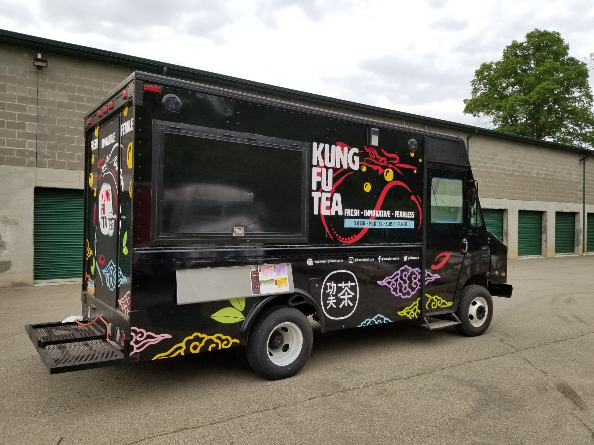 Black Kung Fu Tea food truck with colorful graphics and serving window.