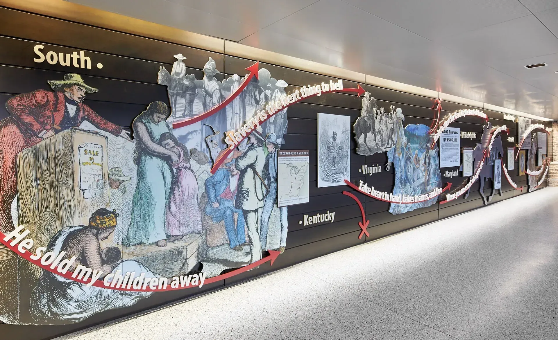 A painting on a wall that says south he sold my children away