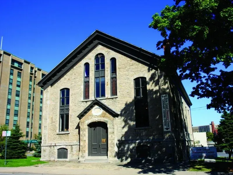 A brick building with a tree in front of it