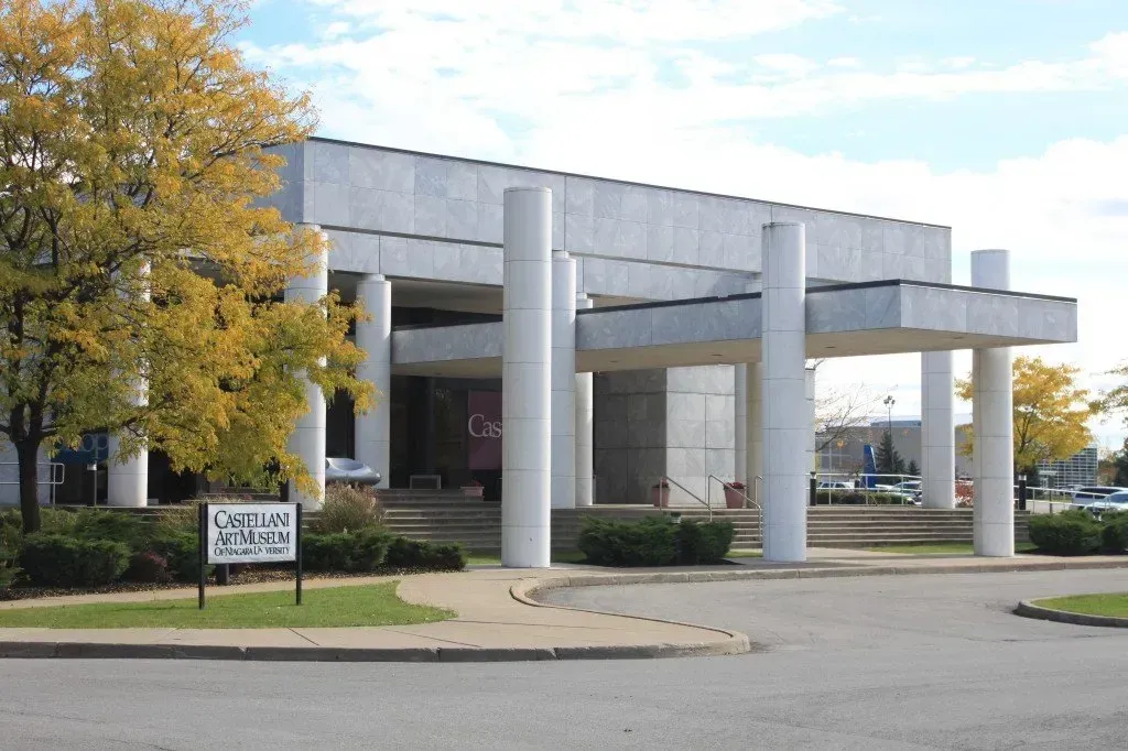 A large building with columns and a sign that says american museum