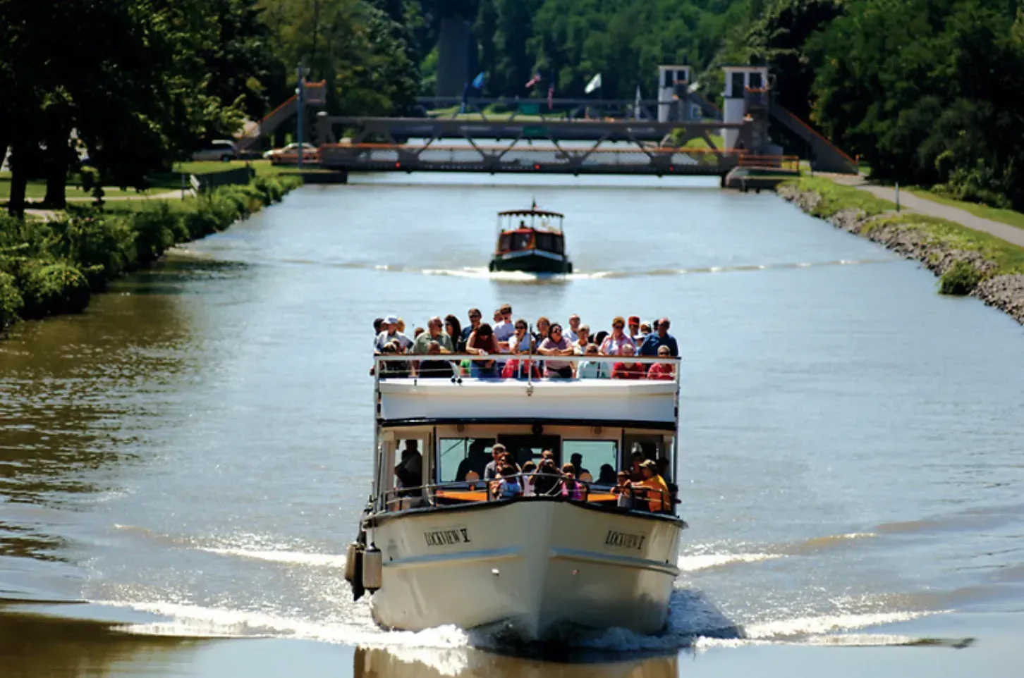 A boat with people on it is going down a river