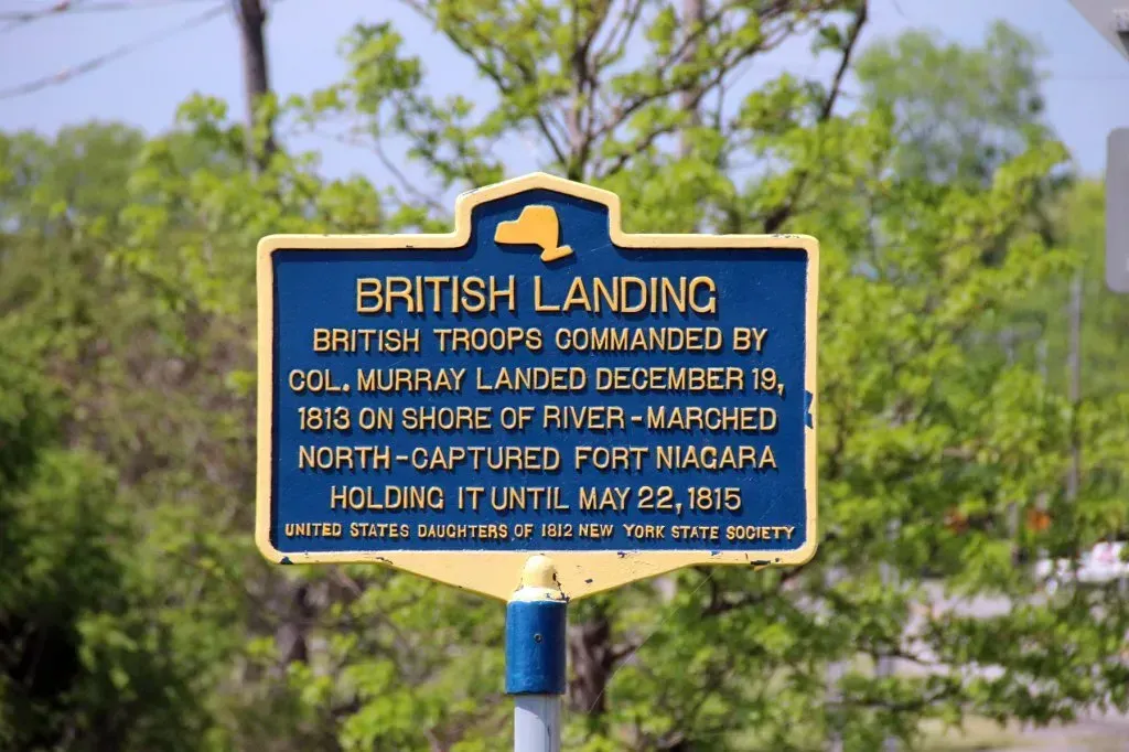 A blue and yellow sign that says british landing on it.