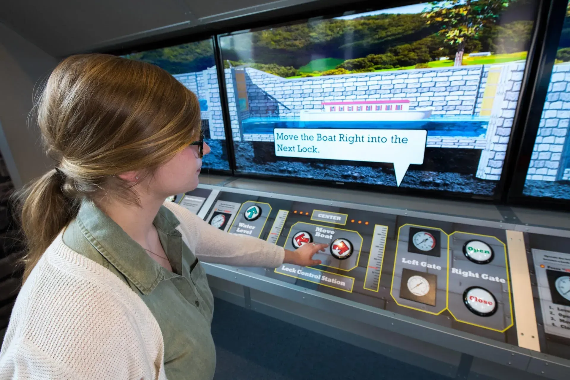 A woman is playing a video game on a computer.