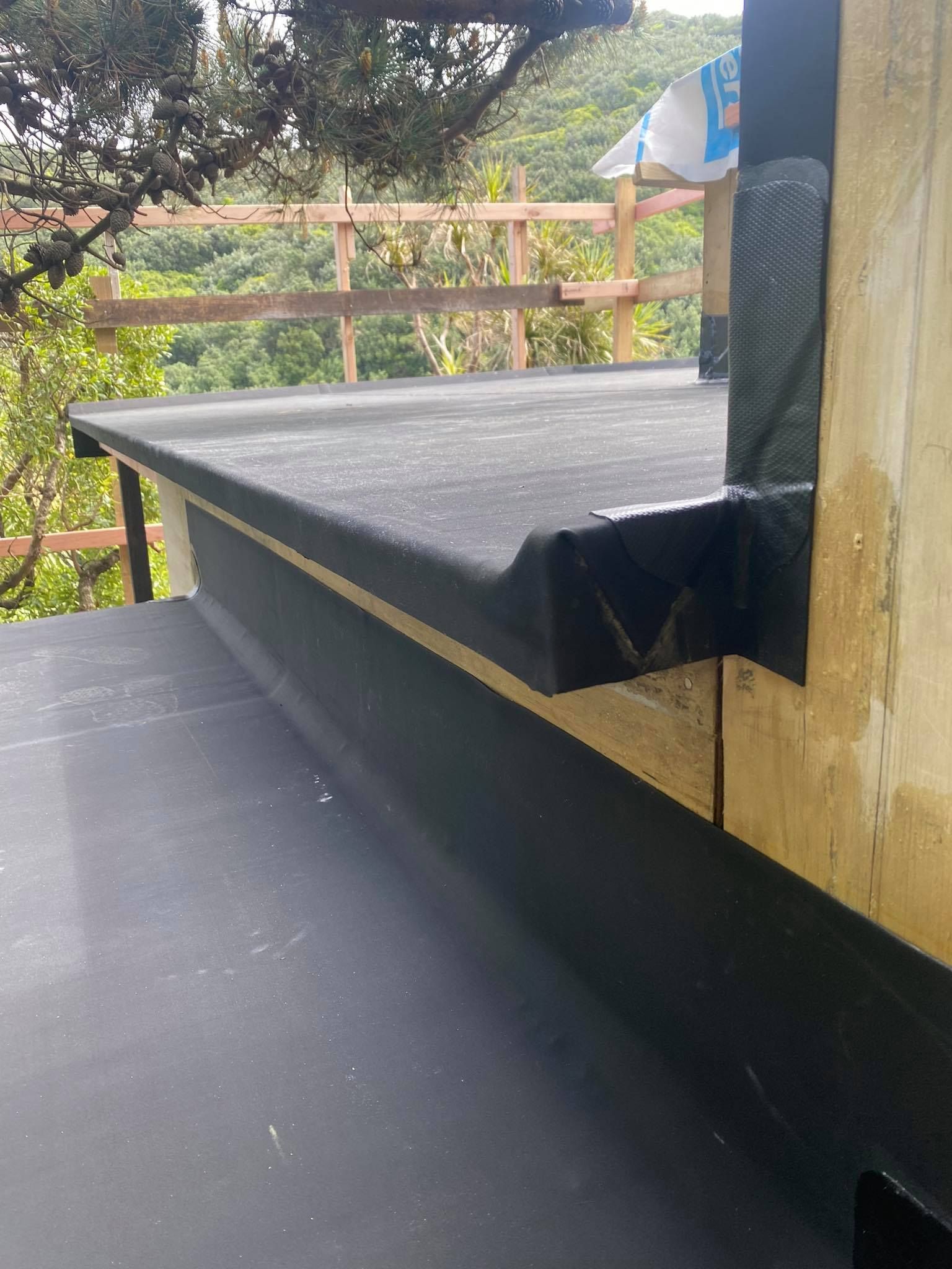 A gutter is being installed on the side of a roof