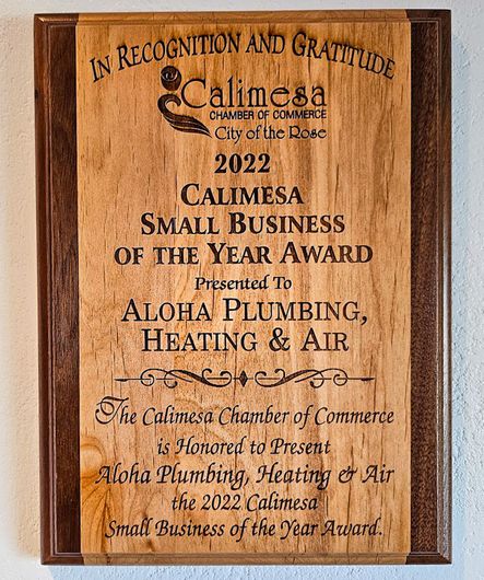 A wooden plaque that says Calimesa small business of the year award