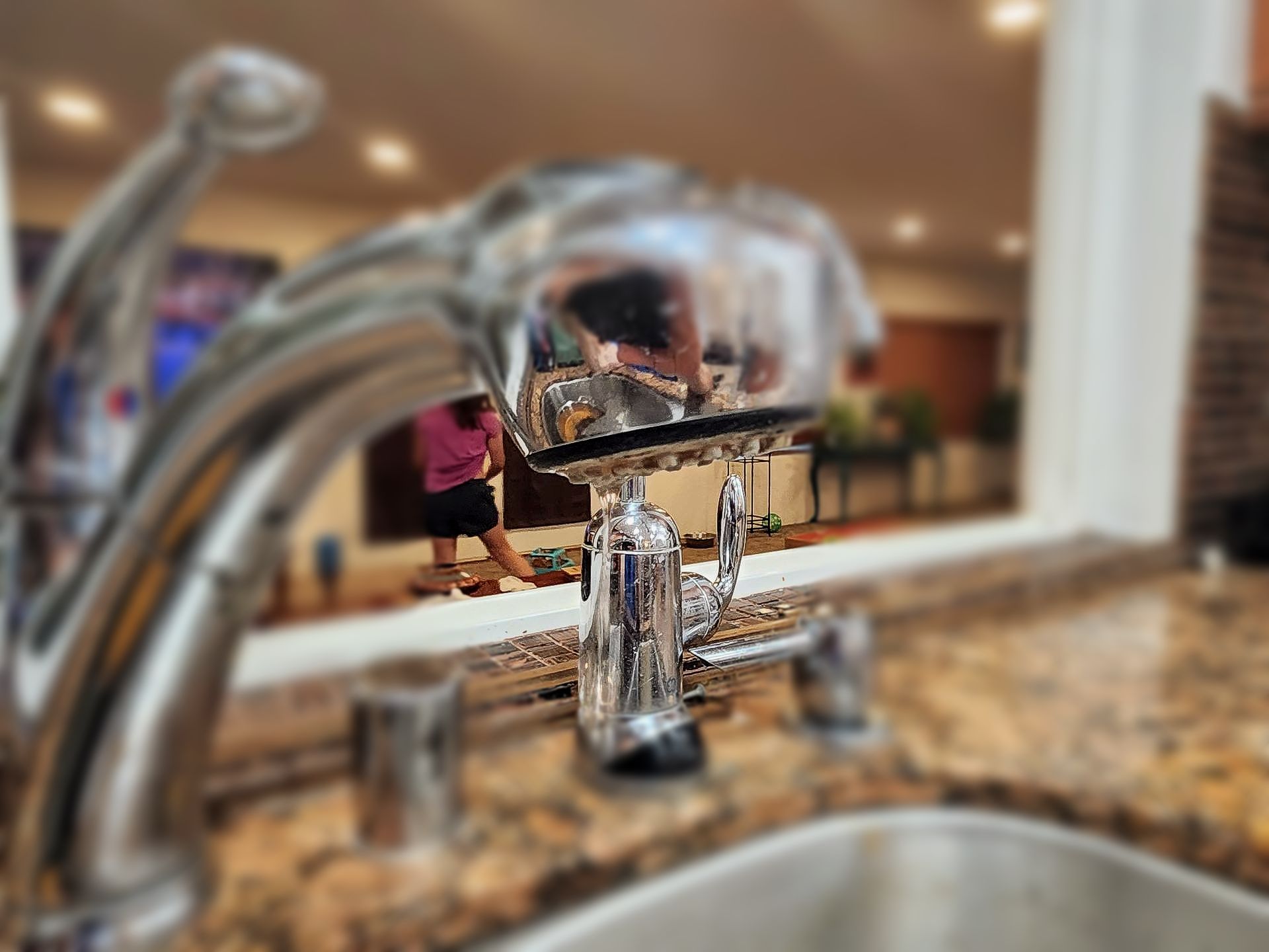 A close up of a kitchen sink with a leaking faucet in Calimesa, CA