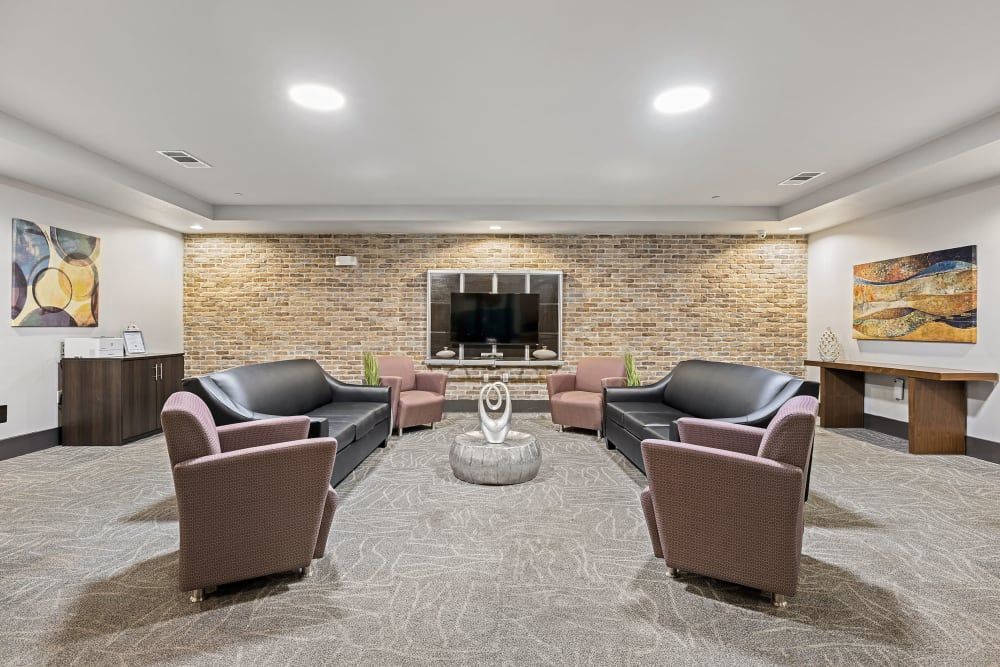 Resident lounge filled with furniture and television at Regents West at 26th in Austin, TX, near UT Austin.