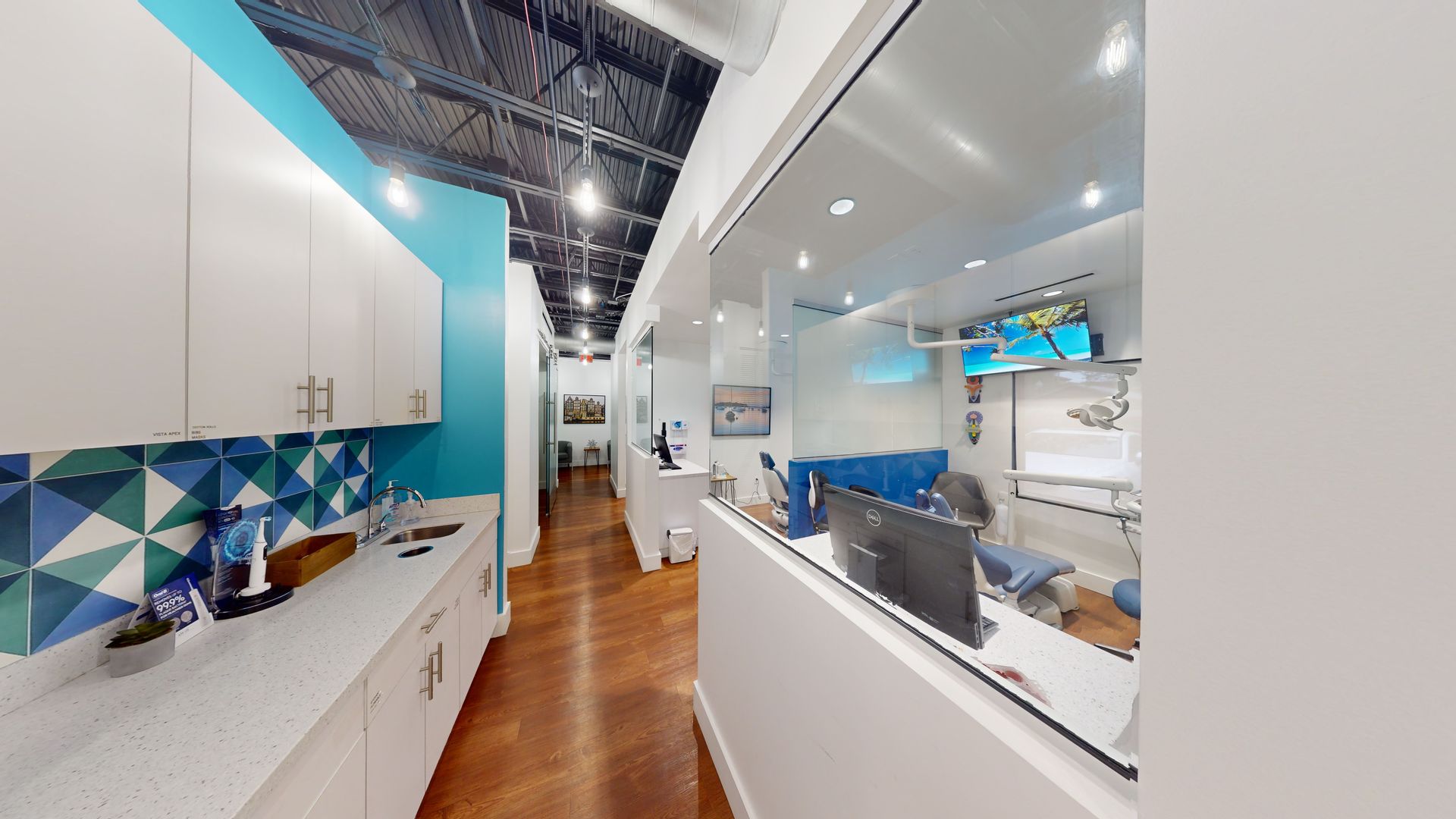A hallway in a dental office with a large window.