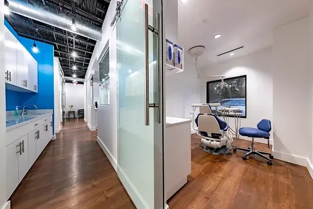 A dental office with a marble counter top and a wooden wall.