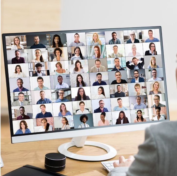 A computer monitor with a collage of people 's faces on it