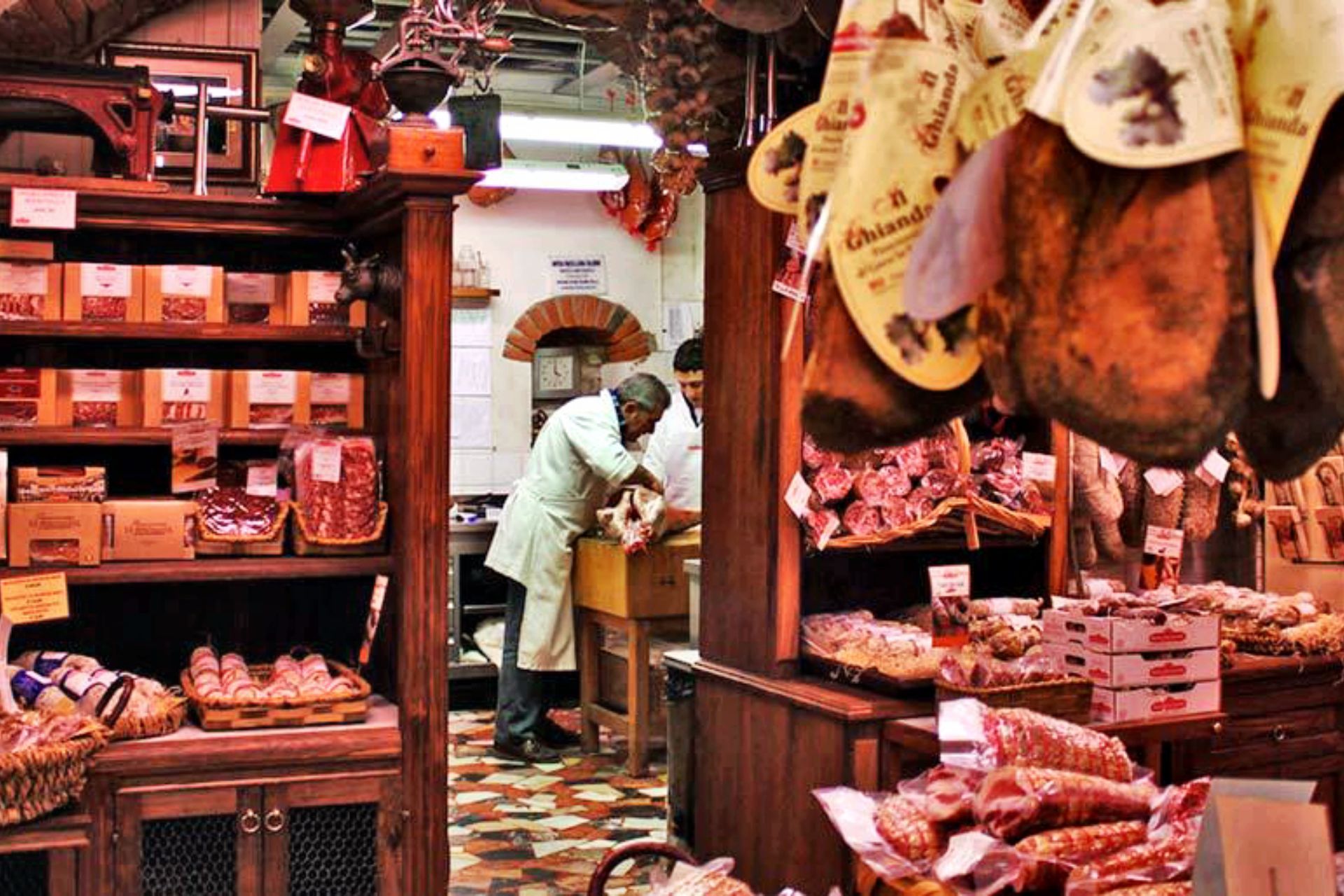 A man in an apron is working in a meat shop