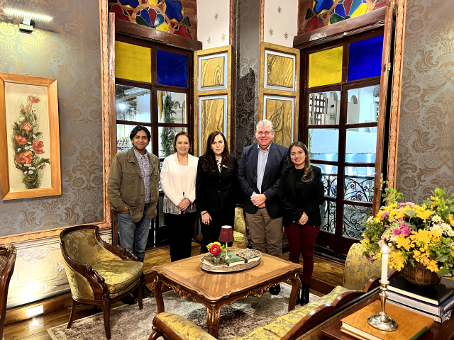 A group of people are posing for a picture in a living room.