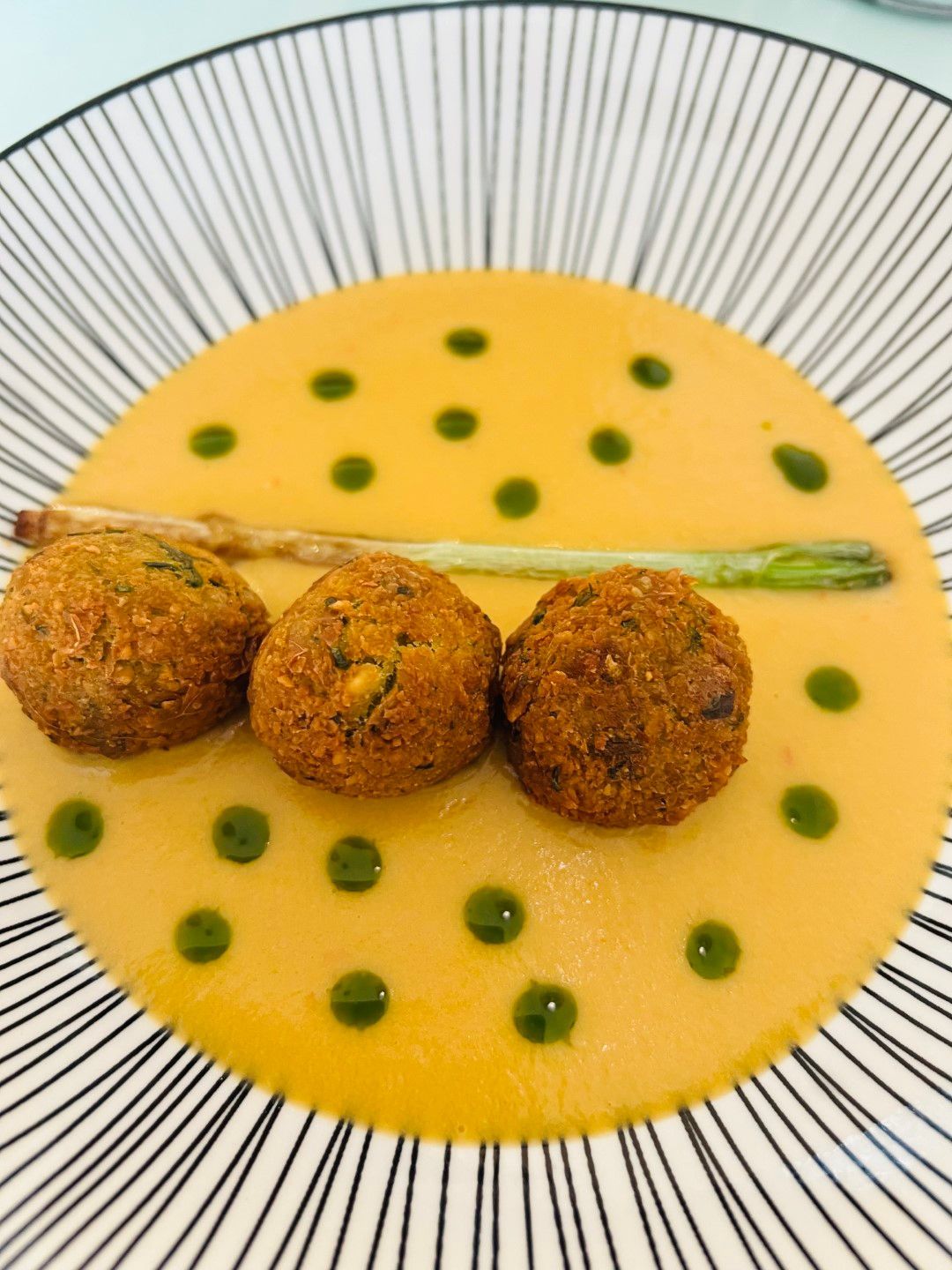 A close up of a plate of food with green dots on it