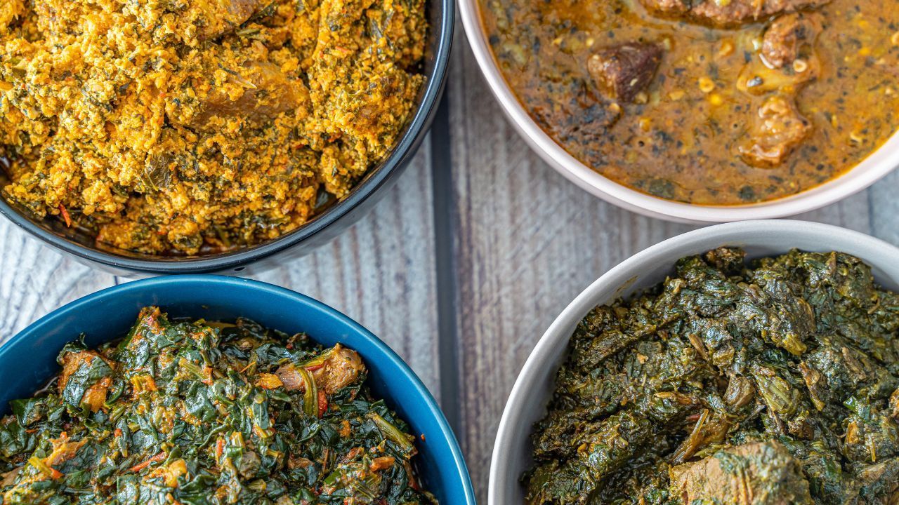 Three bowls of different types of food are sitting on a wooden table.