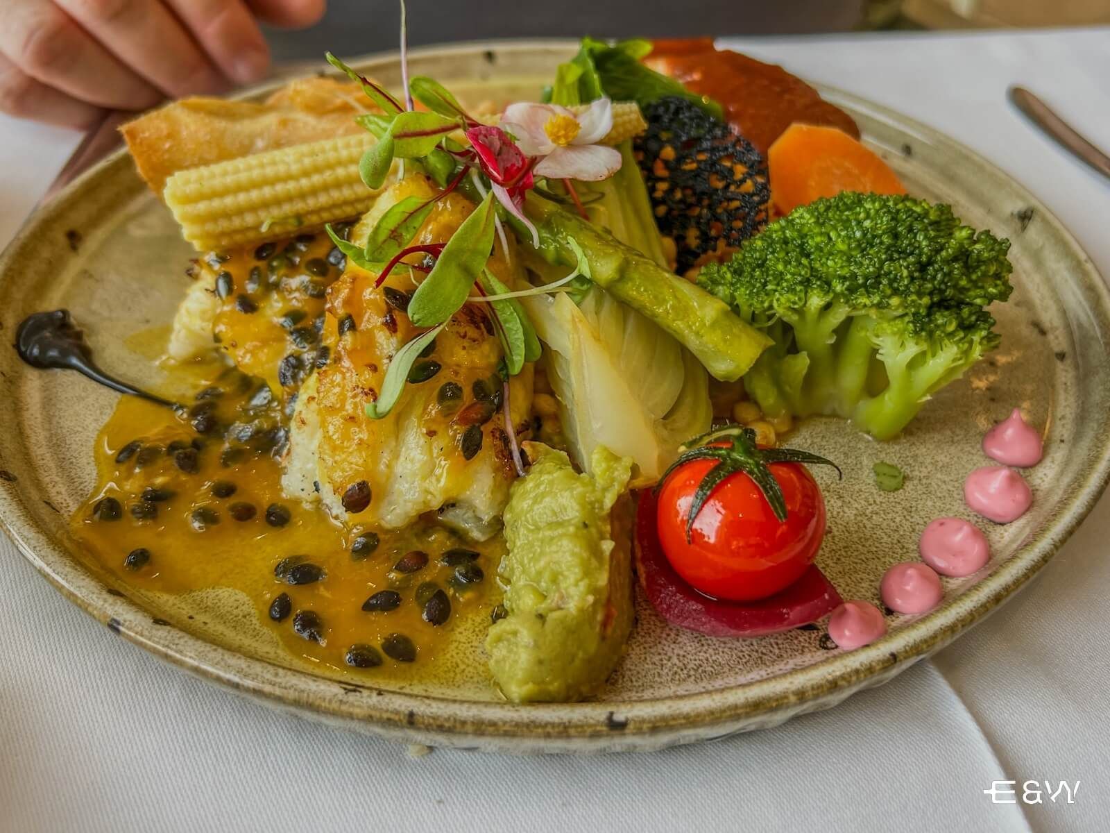 A close up of a plate of food with vegetables on a table.