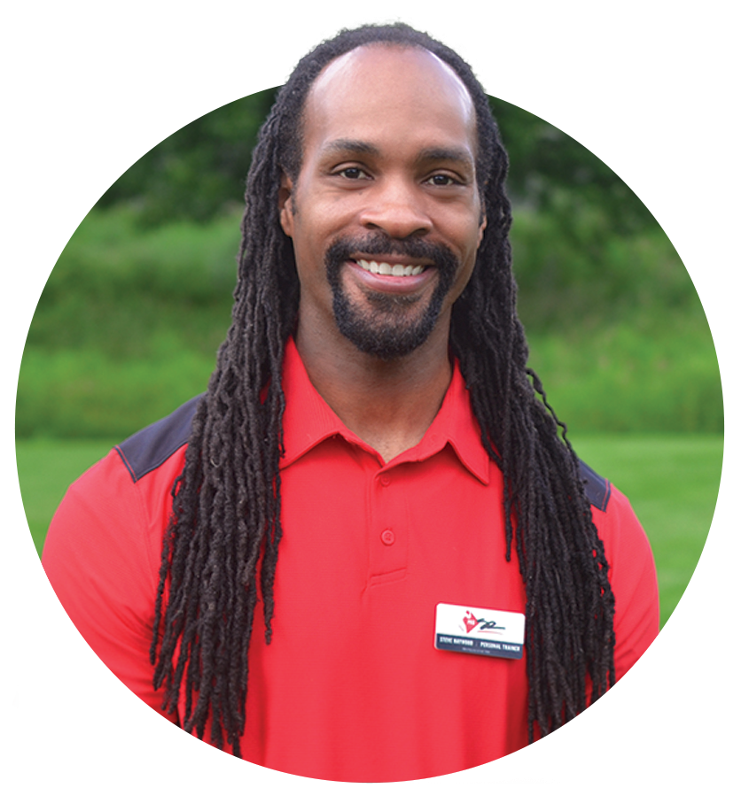 A man with dreadlocks and a beard is wearing a red shirt