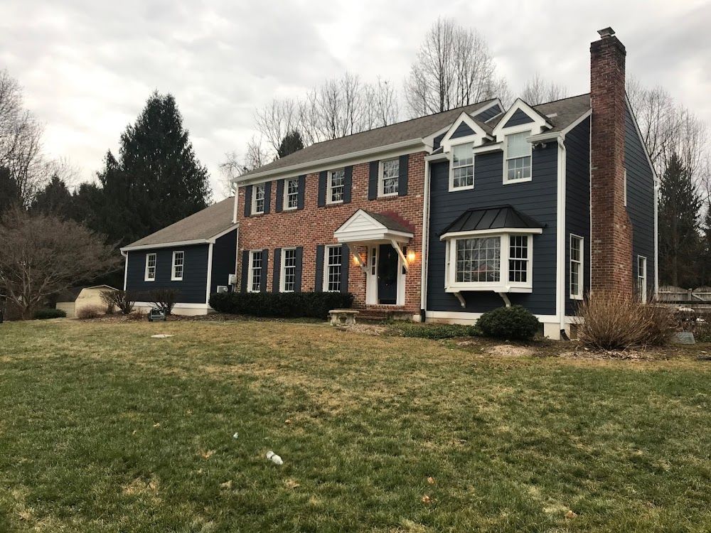 A large house with a large lawn in front of it.