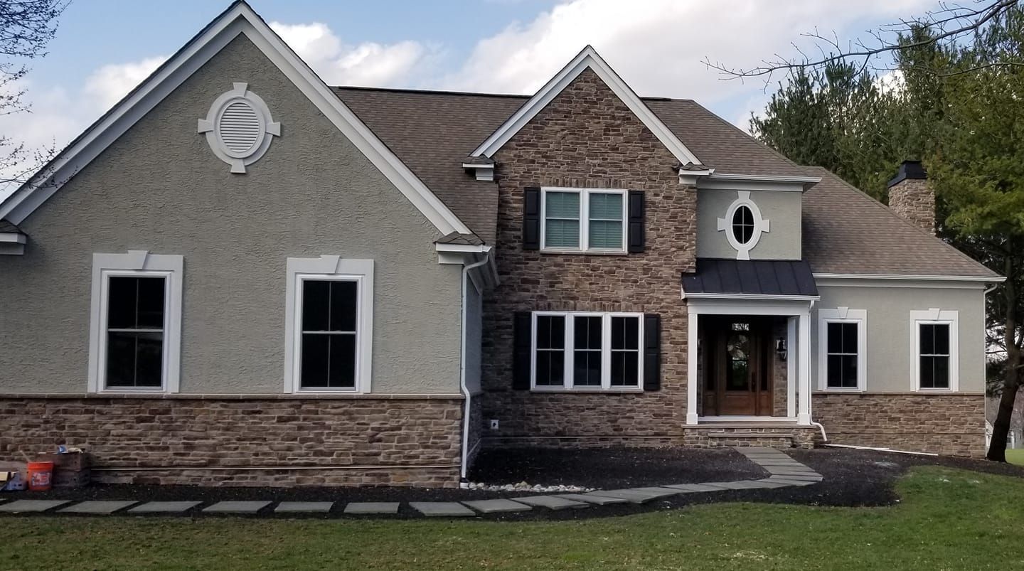 A large house with a lot of windows and shutters