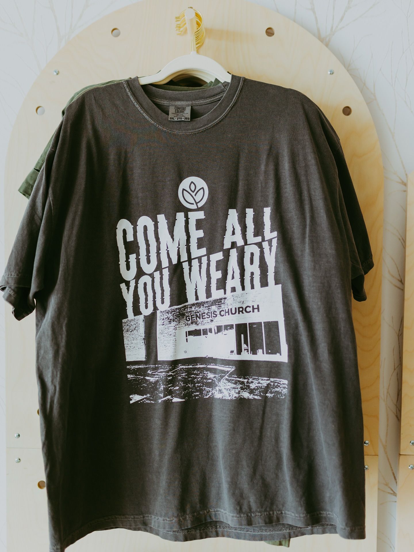 Dark gray t-shirt with white text and graphic: 