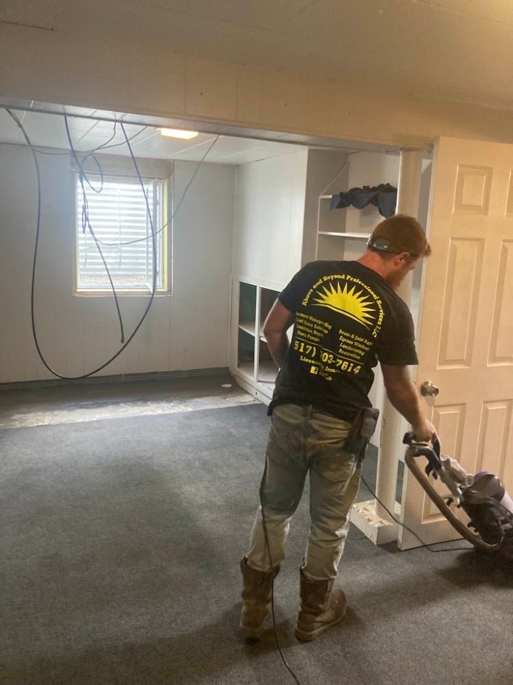 A man is using a vacuum cleaner to clean a carpet in a room.