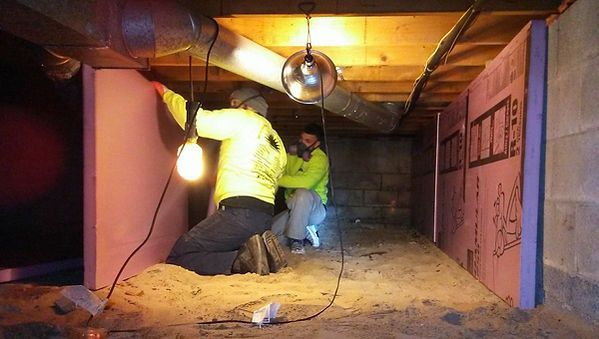 A couple of people are working in a basement.