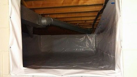 A basement filled with plastic and a window.