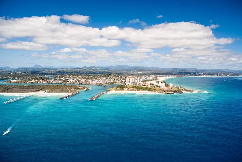 An Aerial View of a City on a Small Island in the Middle of the Ocean — Twin Towns Sand & Gravel In Tweed Coast, NSW
