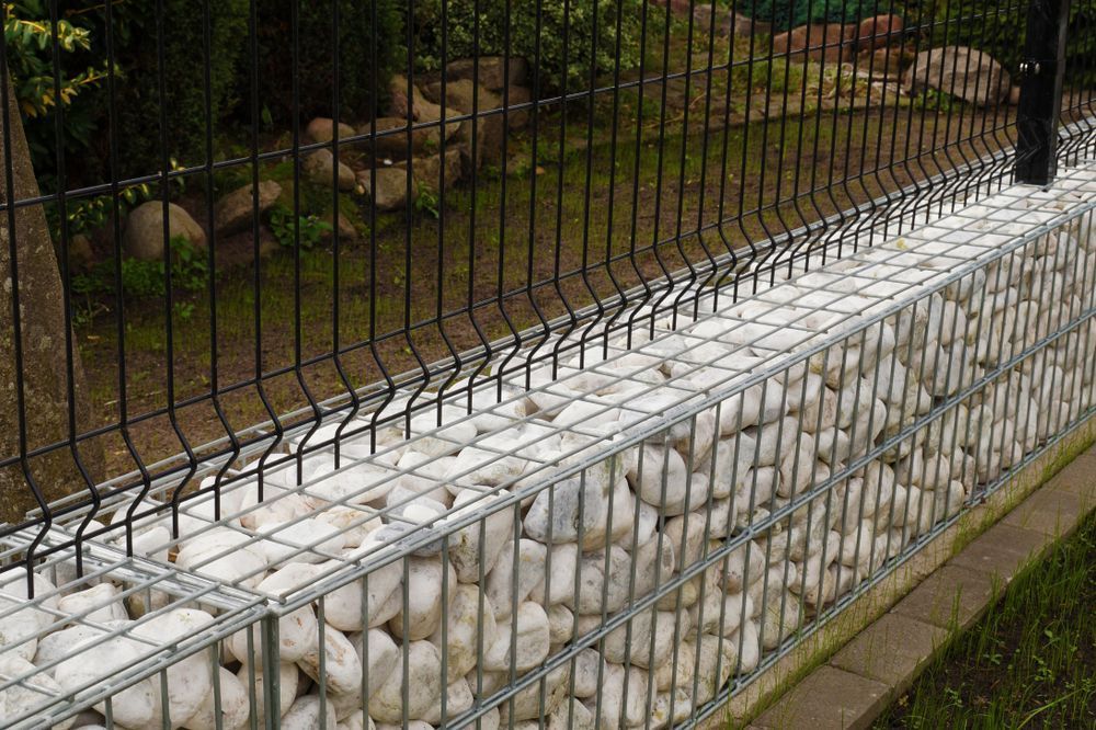 A Fence Made Of Wire And Rocks In A Garden — Twin Towns Sand & Gravel In Tweed Heads South, NSW