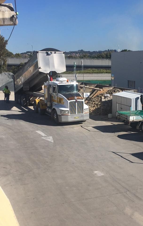 A Dump Truck Is Parked On The Side Of The Road — Twin Towns Sand & Gravel In Pottsville, NSW
