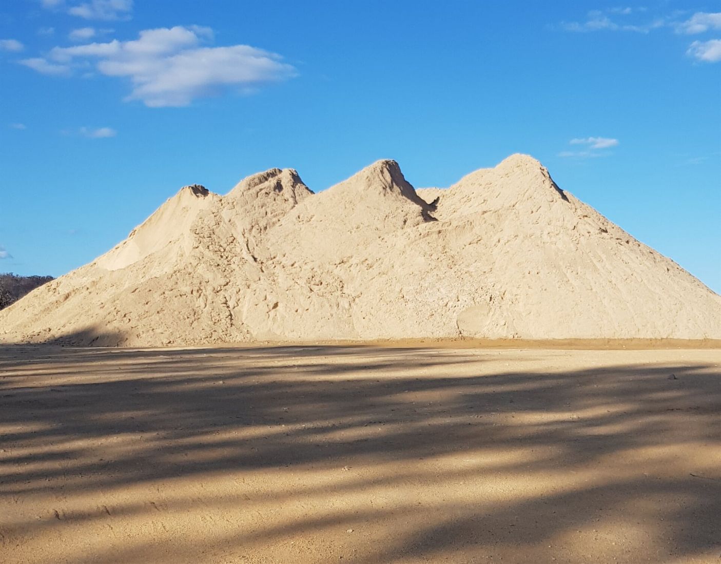 A large pile of Sand is Sitting in the Middle of a Desert — Twin Towns Sand & Gravel In Tweed Heads South, NSW