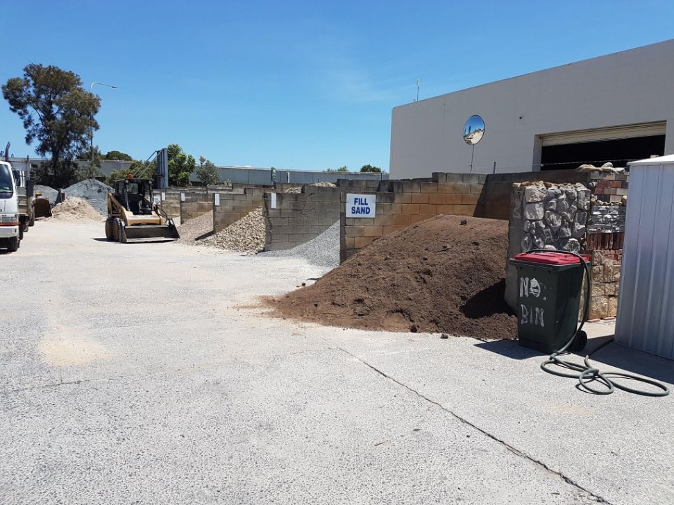 A Large Pile Of Dirt Is Sitting In Front Of A Building — Twin Towns Sand & Gravel In Byron Bay, NSW